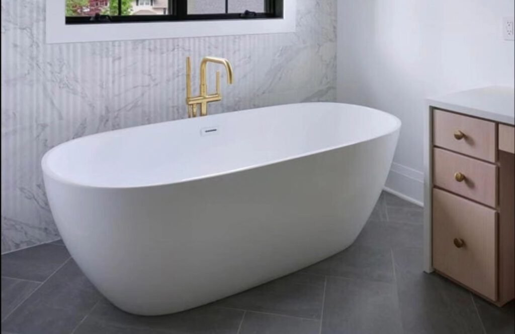 Freestanding tub in front of marble-look feature wall